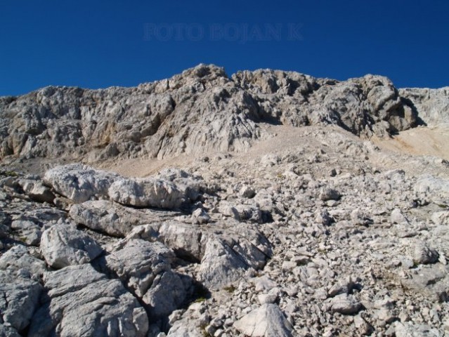 Desno, bolj zgoraj, se že vidi rjavkasto pobočje 